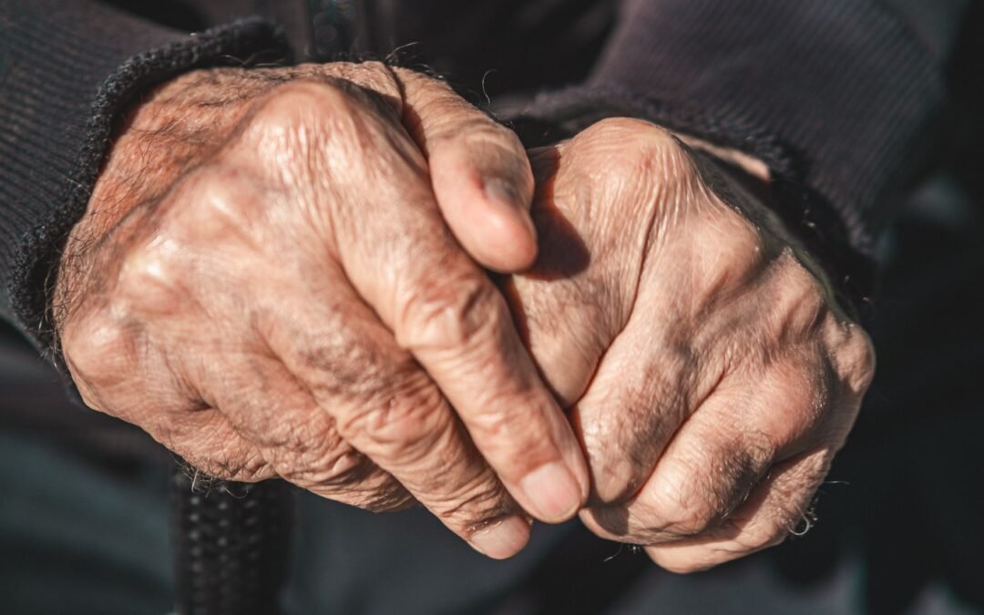 close up of elderly hands in thoughtful pose